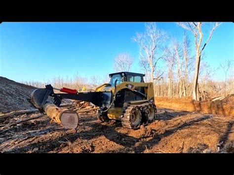 Moving Logs With A Caterpillar Skid Steer Backhoe and Thumb 